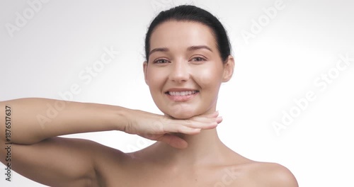Smiling Woman Posing With Hand Under Chin in Bright Skincare Studio