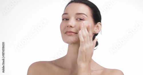 Caucasian Woman Gently Massaging Cheek During Skincare Application