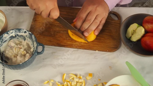 A man prepares fruit ice cream for dessert.