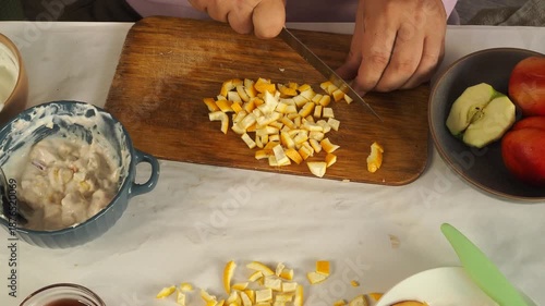 A man prepares fruit ice cream for dessert.