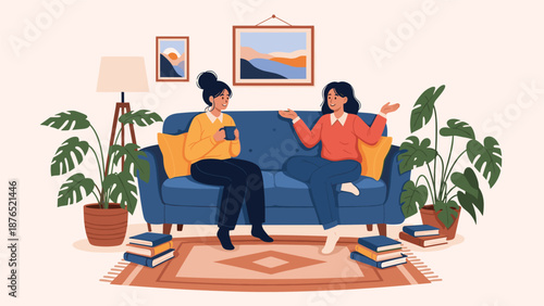 Two young women having a friendly conversation while sitting on a comfortable blue sofa in a cozy living room filled with plants and books.