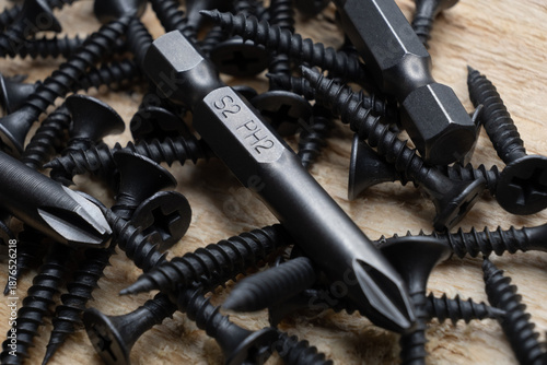 Bits for a screwdriver on a wooden table. macro top view