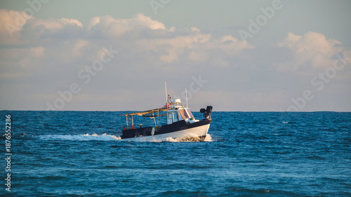 Fishing Boat Cruising Through Deep Blue Sea