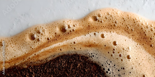 The texture of brewed coffee with creamy foam creates a beautiful and inviting surface for a delicious and aromatic beverage.