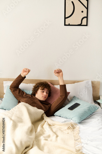 Curly teenager relaxing in a cozy bedroom during a peaceful afternoon at home