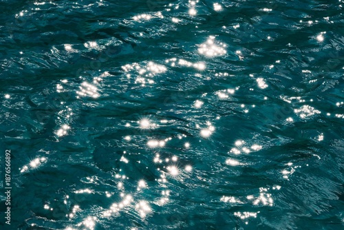 Vibrant sparkling water texture with starburst highlights, perfect for summer or luxury background.
