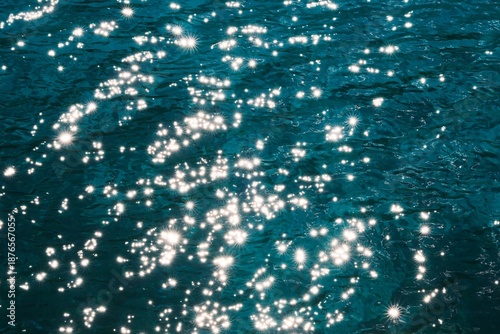 Vibrant sparkling water texture with starburst highlights, perfect for summer or luxury background.