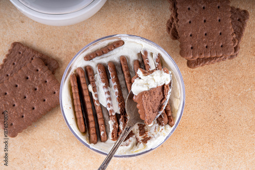 Simple two ingredient yogurt cheesecake in glass, viral tasty quick recipe made with greek yogurt and chocolate biscuits, copy space © ricka_kinamoto