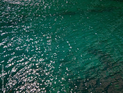 Vibrant sparkling water texture with starburst highlights, perfect for summer or luxury background.