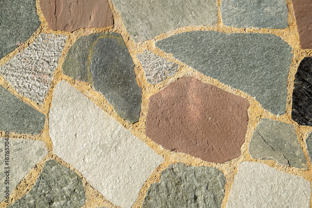 Fototapeta premium Multi Colored Natural Stone Mosaic Texture with Irregular Flagstones and Beige Grout Close Up