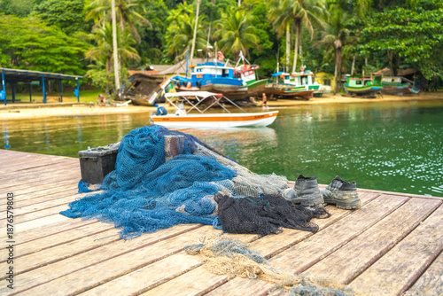 Fishing Nets and Boots on Wooden Pier