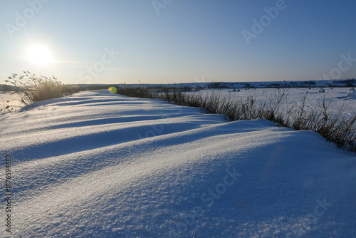 Winter Snowdrifts in Open Landscape at Sunrise