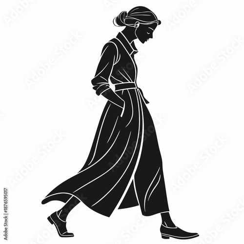 Woman in long belted dress walking profile view long dress