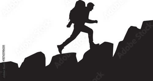 Silhouette of a person hiking on rocky terrain rock climbing