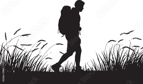 Silhouette of a person hiking with a backpack in a grassy field