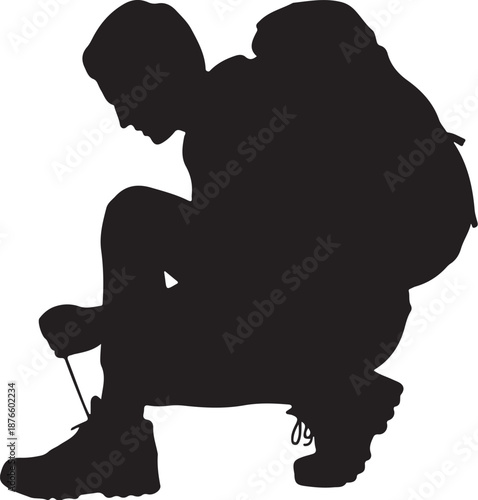 Silhouette of person tying shoelaces in kneeling position
