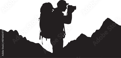 Silhouette of two people hiking with a camera in the mountains
