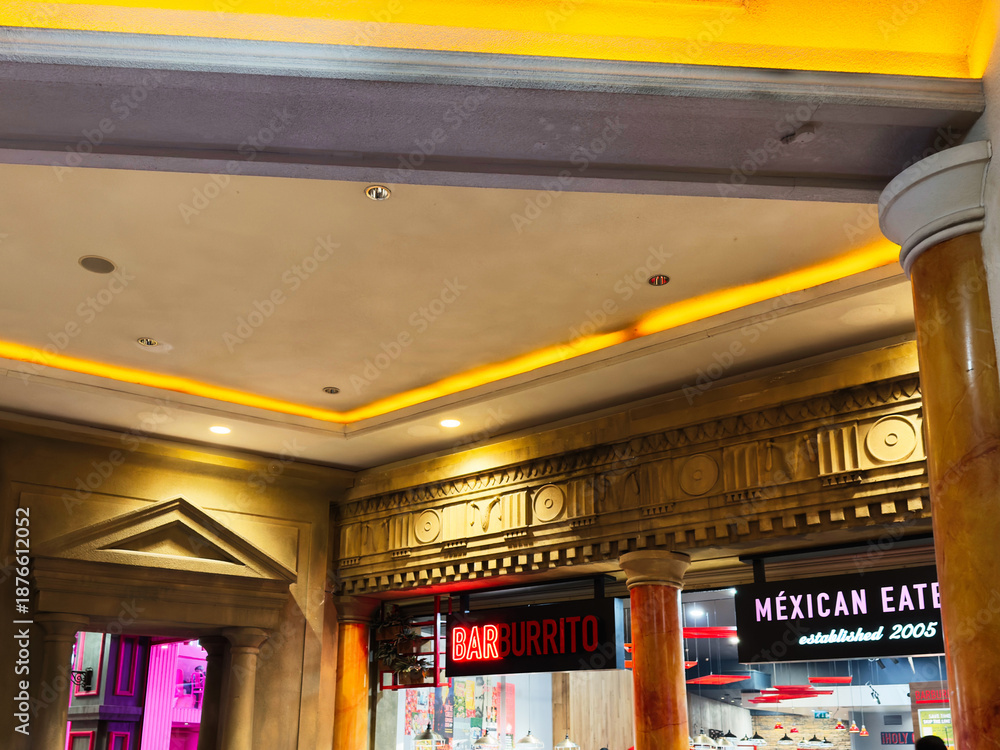 Naklejka premium Inside a Manchester shopping arcade with a bar burrito and Mexican eatery glow