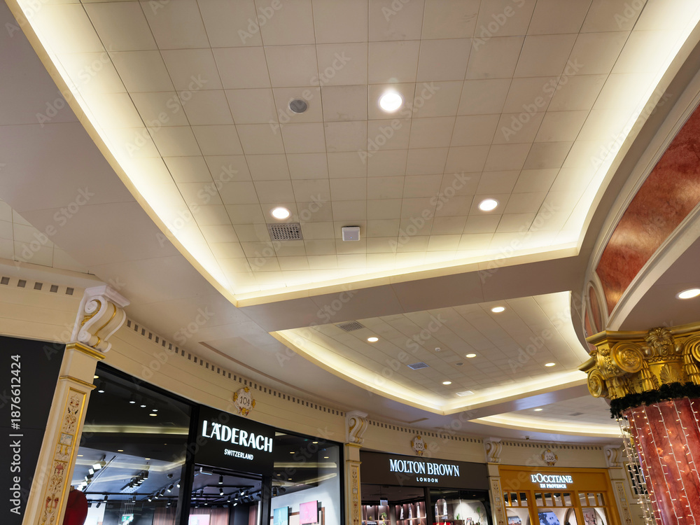Fototapeta premium Elegant shopping mall interior in Manchester UK with ornate ceiling lighting and luxury storefronts