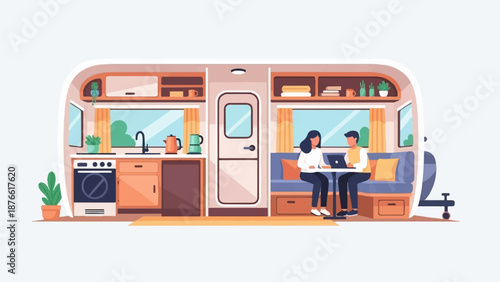 Couple working on laptops inside a cozy, well-equipped RV kitchen and living area