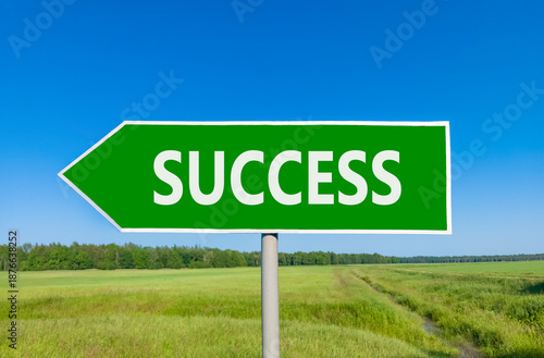 Success symbol. Concept word Success on beautiful green road sign. Beautiful blue sky green grass and forest peaceful nature background. Business success concept. Copy space.