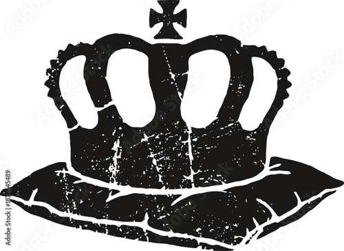 Vintage black distressed crown symbol resting on a cushioned pillow, royal emblem design