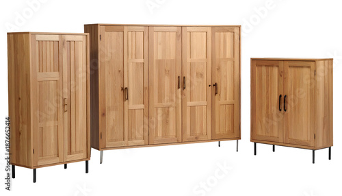 Group of three wooden cabinets of varying sizes with black legs against a dark background