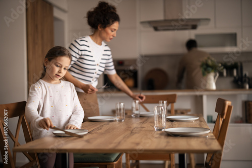 Family preparing for lunch together in modern home kitchen