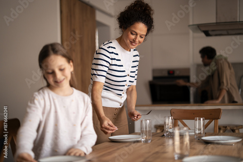 Fotografi Family preparing lunch together in modern home kitchen