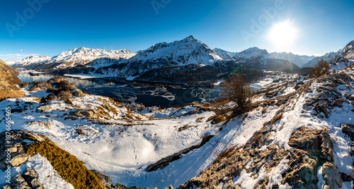 A view of Lake Sils and the Chaste peninsula from above. Panorama from Grevasalvas in winter.
