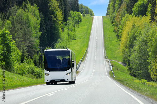 Highway landscape with a white bus traveling through beautiful rural scenery.  Copy space. 