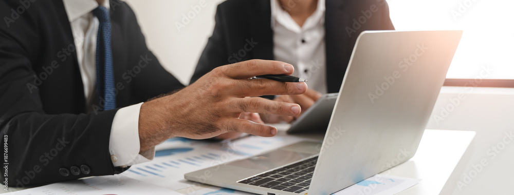 Naklejka premium financial advisory services. Asian advisor showing plan of investment to clients in the consultancy office.