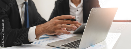 financial advisory services. Asian advisor showing plan of investment to clients in the consultancy office. © Pormezz