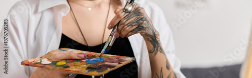 Creative young woman enjoys painting at home during afternoon light and comfort