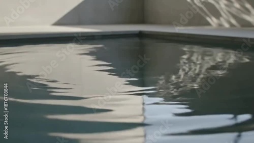 Abstract Play of Light and Shadow on Tranquil Pool Water, Creating a Serene and Modern Architectural Scene