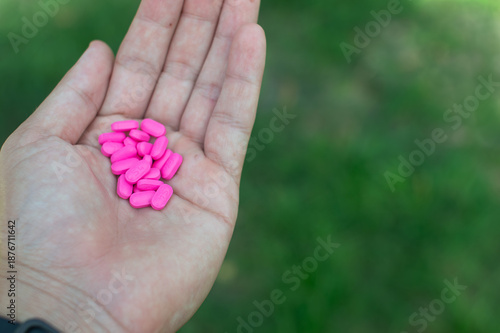 Photography Hand Holding Pink Antihistamine Tablets for Allergy Relief