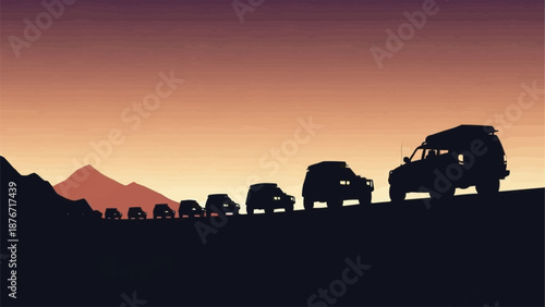 Off road vehicles driving in a convoy at sunset.