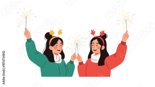 Two joyful friends wearing holiday reindeer headbands celebrate the winter season while holding glowing sparklers together.