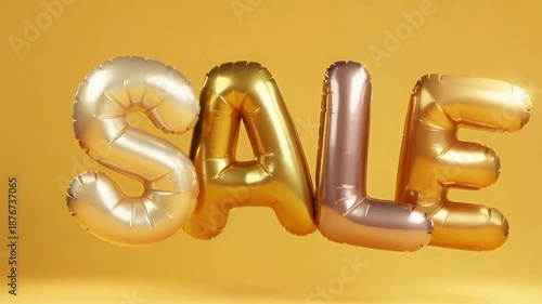 Gold and metallic balloons spelling out the word sale floating against a yellow background