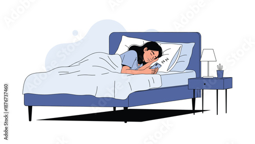 Young woman sleeps peacefully in a cozy blue bed while still clutching a glowing smartphone in her hand at night.