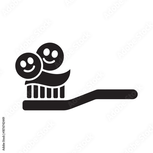 Smiling faces on a toothbrush promoting dental health and hygiene