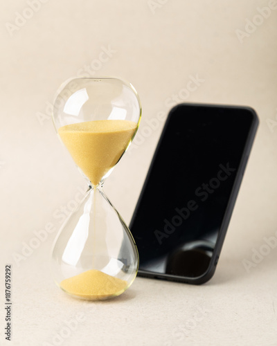 Hourglass on wooden blocks spelling DETOX with a heart symbol. A conceptual image for digital detox, mental health, self-care, and loving yourself by disconnecting from technology distractions.