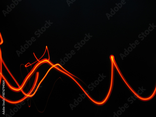 Vibrant orange light trails on black background
