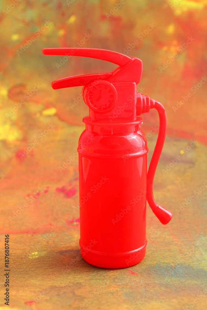 Obraz premium Fire extinguisher. Background stains simulating a fire - vertical format