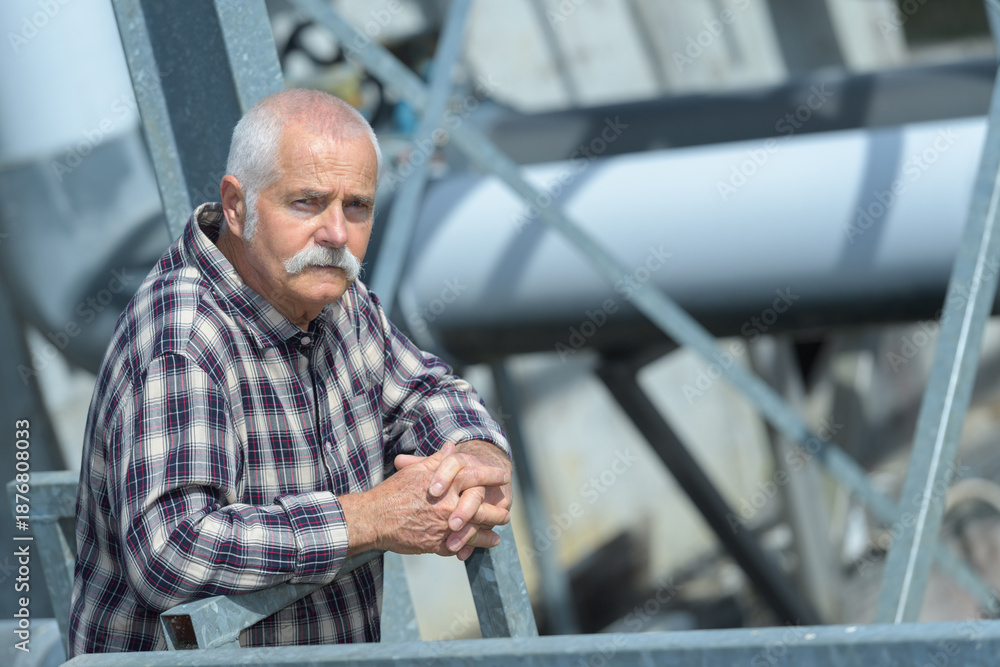 Fototapeta premium mature man standing on waste water treatment unit