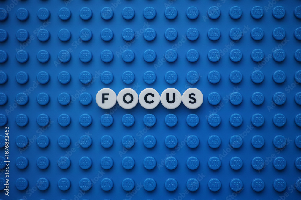 Fototapeta premium Tambov, Russian Federation - January 14, 2026 The word Focus on a blue Lego baseplate. The scene is made out of Lego dots.