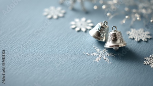 Silver Christmas Bells and Snowflakes on Calm Blue Background for Festive Holiday Decor and Celebrations