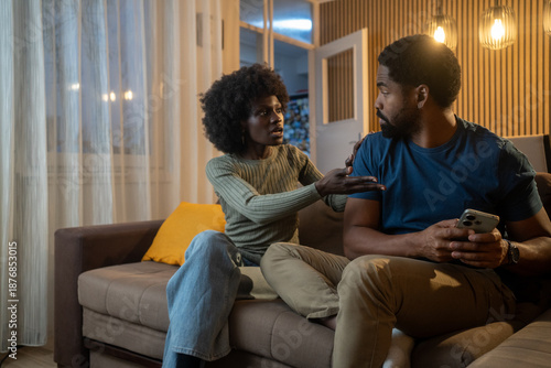 Obraz na plátne Young Black woman demanding phone from boyfriend hiding texts and secrets