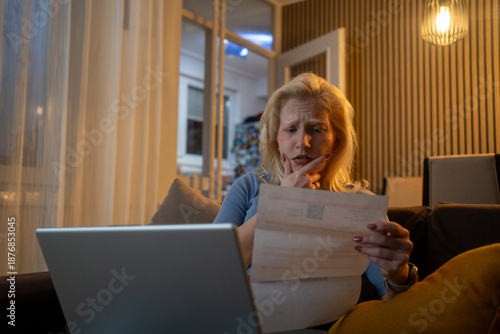 Photography Pensive woman feeling worried while working on home finances.