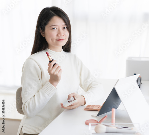woman holding a lipstick